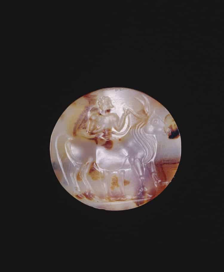 Agate Intaglio Carving of a Man Leading a Bull c. 1450-1300 BC. © Trustees of the British Museum.