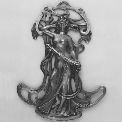 Pierced and Chased Silver and Parcel-Gilt Pendant in the Form of a Standing Female Figure with Flowing Draperies. 1900-1905 (circa) © The Trustees of the British Museum.