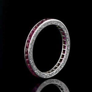 French-Cut Ruby and Platinum Engraved Eternity Band.