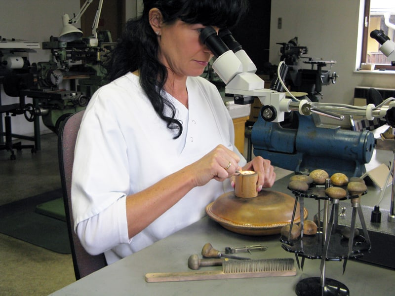 A Master Engraver uses Gravers to Decorate the Movement on a Swiss Watch.