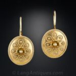 Castellani Victorian Etruscan Revival Disk Form Earrings with Granulation and Wirework Decoration.