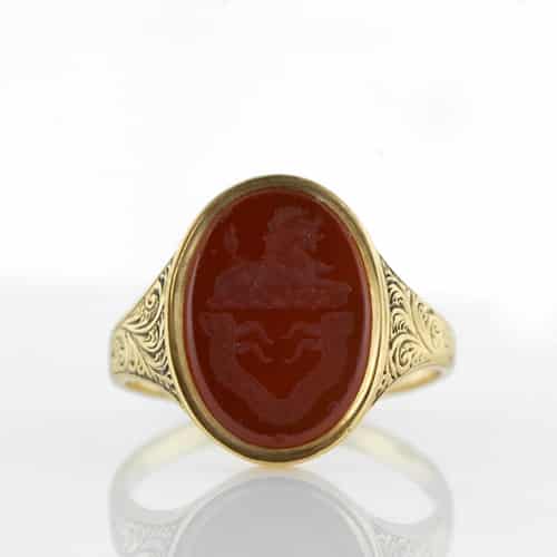 Signet Ring with Reddish Orange Carnelian Intaglio of a Regal Lion with Scroll Motif Shoulders, Mid Victorian.