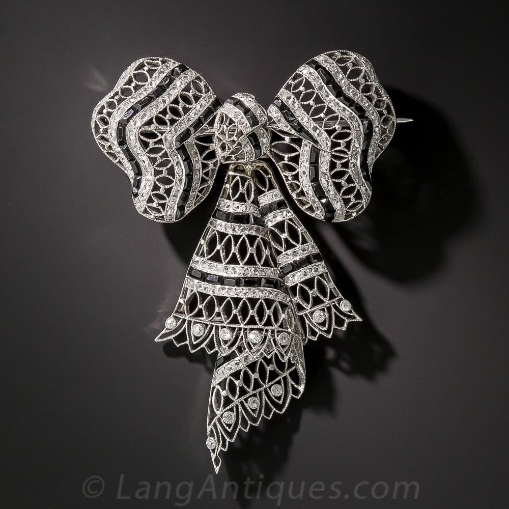 Edwardian Diamond, Onyx and Platinum Bow Knot Brooch.