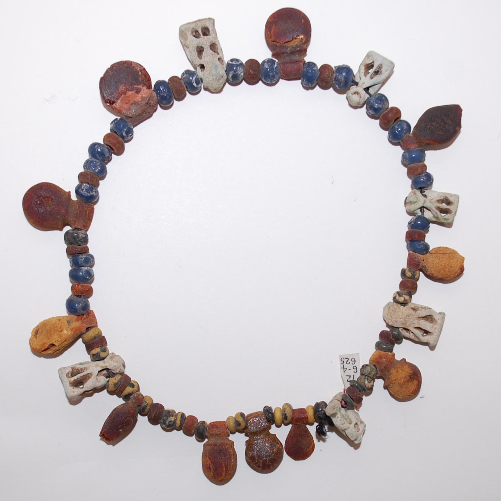 Amber Pendants, 18 Amber Beads, and Blue, Black and Yellow Glass Beads, with 6 Faience Pendants. c.7th Cen,. BC. © Trustees of the British Museum.