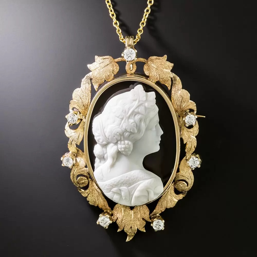 Hardstone Cameo in a Leaf and Scroll Motif Diamond Set Frame.