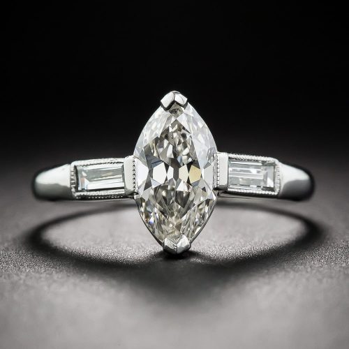 Art Deco Marquise Diamond and Platinum Engagement with Baguette Shoulders and Millegrained Accents.