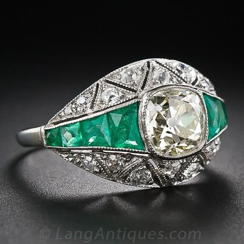Art Deco Diamond and Platinum Engagement Ring with Calibre Emerald Shoulders an Millegrained Geometric Segments.