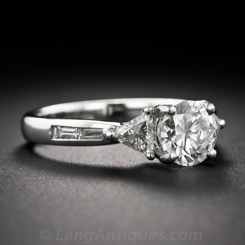 Round Brilliant-Cut Diamond and Platinum Engagement Ring With Trillion and Baguette-Cut Shoulders.