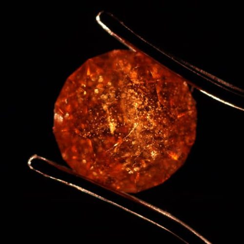 A Very Included Spessartite Garnet. This Stone has a Very Low Clarity Grade of I3.