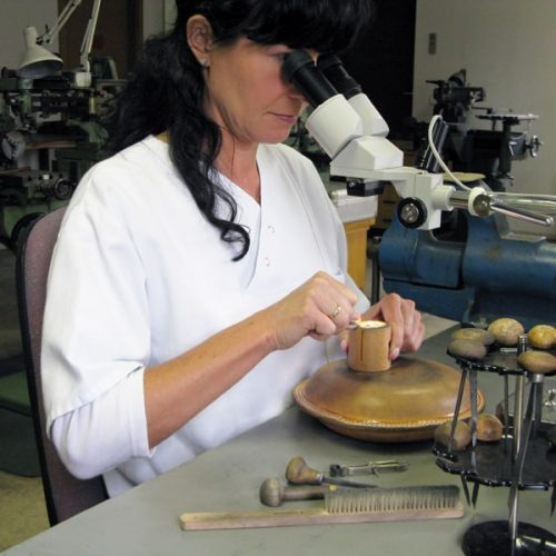 A Master Engraver uses Gravers to Decorate the Movement on a Swiss Watch.