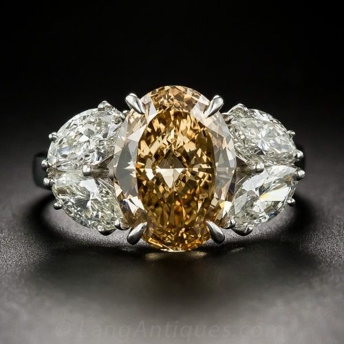 Oval Fancy Deep Brownish Yellowish Orange. Diamond with Two Pair of Marquise-Cut Side Stones.