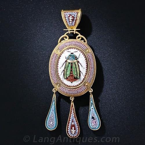 Ancient Egyptian Revival style pendant necklace featuring an iridescent scarab that has alighted smack in the center of an intricately designed and executed micro-mosaic cartouche