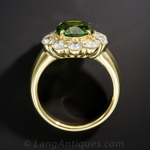Green Tourmaline and Diamond Halo Ring. The Tourmaline Color is a More Olive Green from this Crystal Direction – Exhibiting Pleochroism. Green Tourmaline and Diamond Halo Ring. The Tourmaline Color is a More Olive Green from this Crystal Direction - Exhibiting Pleochroism.